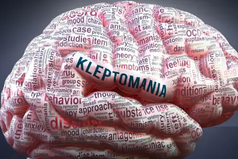 Mózg wypełniony słowami, z napisem "KLEPTOMANIA" na środku. Obraz symbolizuje zaburzenie, jakim jest kleptomania.